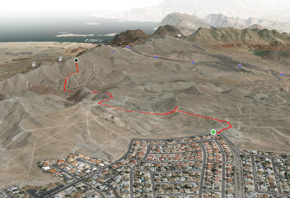 An overhead, 3D satellite view of a city near Lake Mead, and a plotted route along ORV trails. 