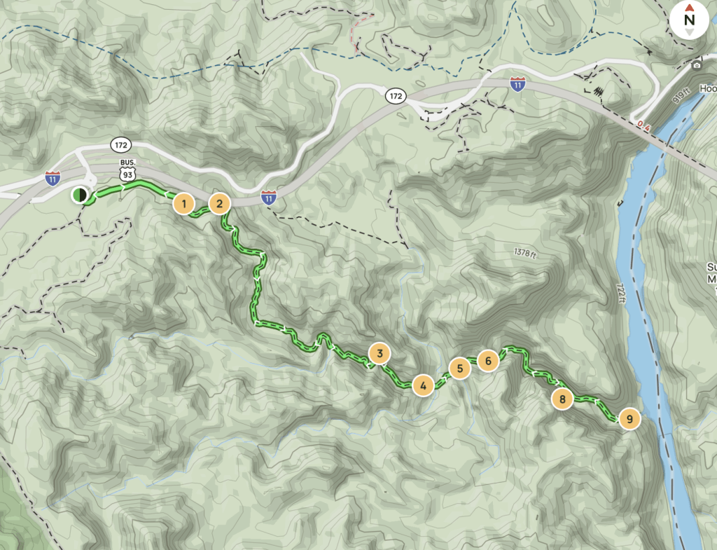 Topographic map showing a winding hiking or trail route (green) through mountainous terrain with numbered waypoints 1–9 and a river on the right.